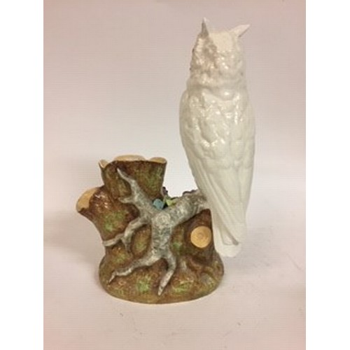 603 - A Moore Brothers figure of a long eared owl, perched on a branch, impressed mark to base, 33 cm high