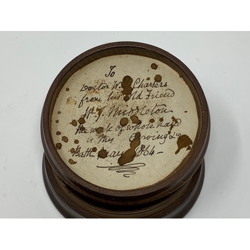 480 - A treen snuff box, the cover carved a horse's head, the inside with a paper label inscribed and date... 