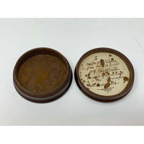 480 - A treen snuff box, the cover carved a horse's head, the inside with a paper label inscribed and date... 