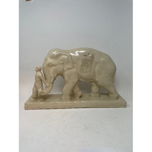620 - A pottery group, of an elephant and attendant, 25 cm high