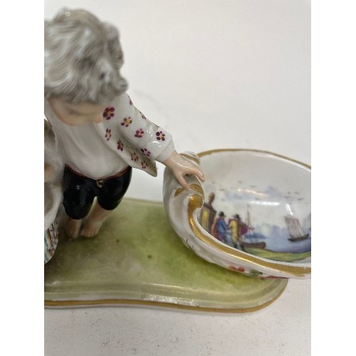 623 - A Meissen figural salt, the bowl interior painted figures and ships, 15 cm wide