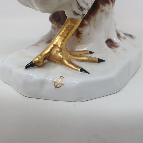 604 - A Continental porcelain model of a cockerel, 28 cm high, and a matching chicken, 22 cm high (2)