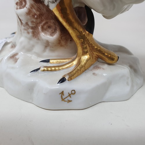 604 - A Continental porcelain model of a cockerel, 28 cm high, and a matching chicken, 22 cm high (2)