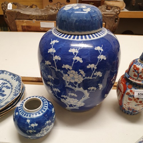 655 - A large Chinese ginger jar, decorated blossom, with associated cover, 29 cm high, and another ginger... 