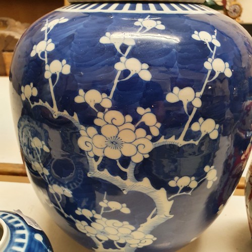 655 - A large Chinese ginger jar, decorated blossom, with associated cover, 29 cm high, and another ginger... 