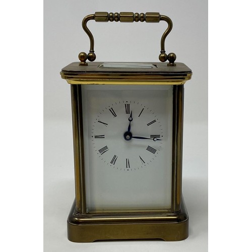 235 - A carriage timepiece, the 5.5 cm wide enamel dial with Roman numerals, in a brass case, 14 cm high