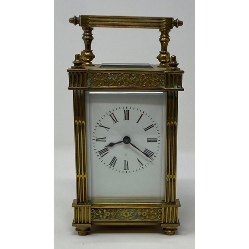 237 - A brass carriage timepiece, the 5.5 cm wide enamel dial with Roman numerals, in a brass case with fl... 