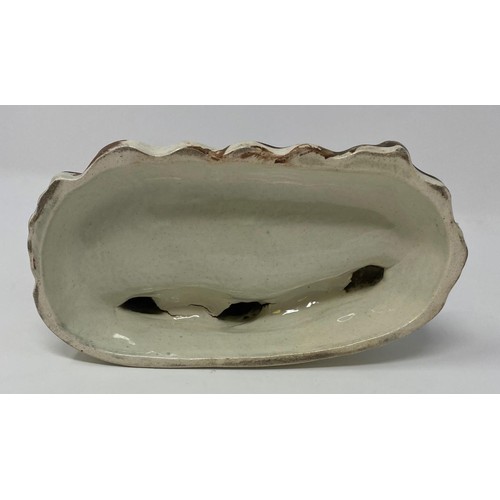 569 - An early 19th century Staffordshire group, of two men and a dancing bear, 16 cm high