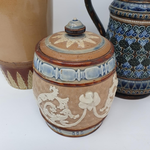 504 - A Doulton Lambeth jug and cover, decorated foliate forms, 26 cm high, a tobacco jar, 16 cm high and ...