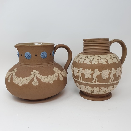 508 - A Doulton Lambeth tobacco jar, 15 cm high, and two Doutlon Lambeth jugs (3)...