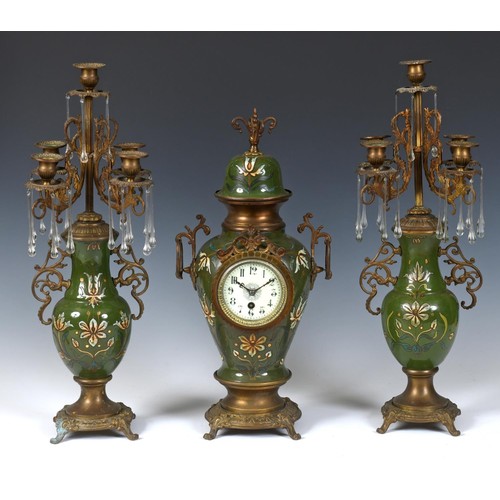 193 - A clock garniture, the clock with an 8.5 cm diameter dial having Arabic numerals, in a pottery and g... 