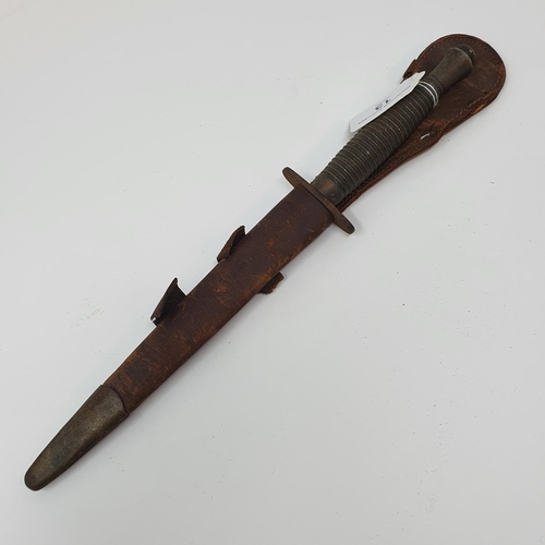 13 - A Fairbairn & Sykes type Commando fighting knife, with a ribbed handle, and a leather scabbard
Prove... 