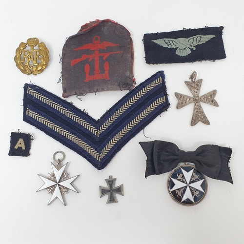 16 - An Order of St John neck badge, a breast badge, and a small group of militaria items...