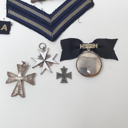 16 - An Order of St John neck badge, a breast badge, and a small group of militaria items