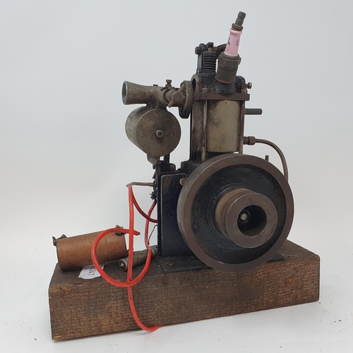 335 - A small single cylinder petrol engine, with a pulley wheel, possibly for powering a toy motor launch... 