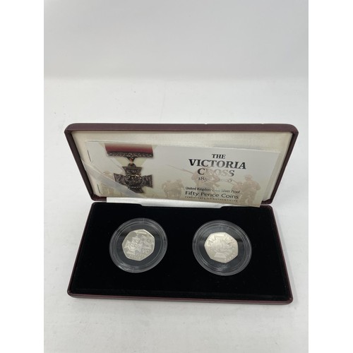 39 - A pair of Victoria Cross silver proof 50p coins, and other similar sets...