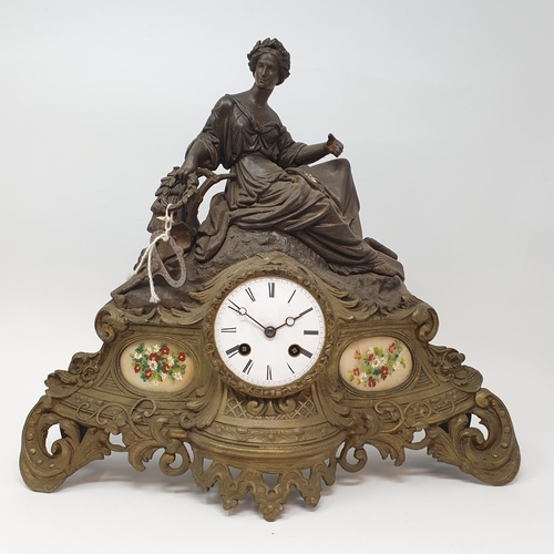 195 - A late Victorian mantel clock, the 8 cm diameter enamel dial with Roman numerals, in a spelter figur... 