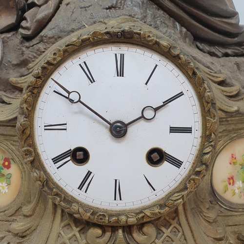 195 - A late Victorian mantel clock, the 8 cm diameter enamel dial with Roman numerals, in a spelter figur... 