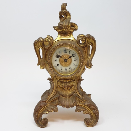 199 - A timepiece, the 5 cm diameter dial signed Ansonia, with Arabic numerals, in a gilt brass rococo sty... 