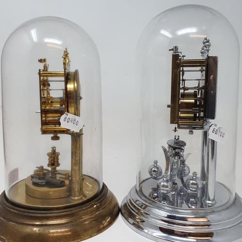 205 - A 400 day brass clock, under a glass dome, 28 cm high and another similar (2)