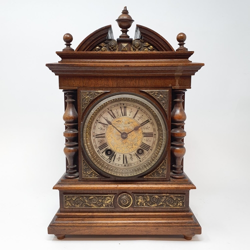 218 - A mantel clock, the 11 cm diameter silvered dial with Roman numerals, in walnut case 33 cm high