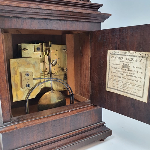 218 - A mantel clock, the 11 cm diameter silvered dial with Roman numerals, in walnut case 33 cm high