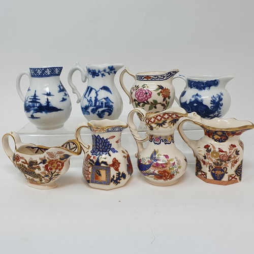 518 - A Royal Doulton figure Dinky Do, HN1678, seven modern Royal Worcester blue and white cream jugs and ...