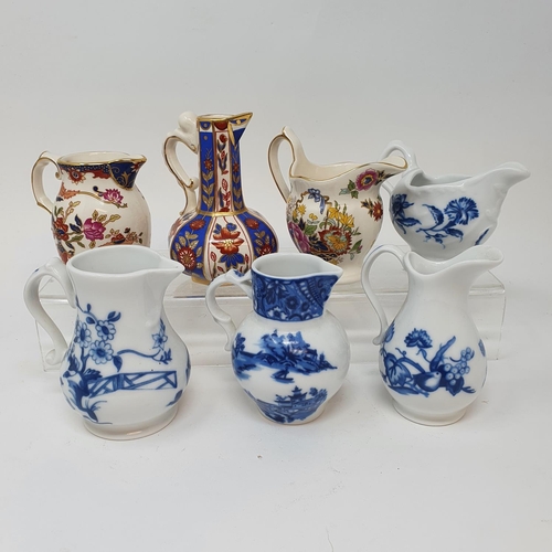 518 - A Royal Doulton figure Dinky Do, HN1678, seven modern Royal Worcester blue and white cream jugs and ...