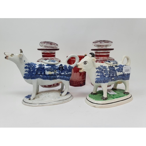 530 - A Staffordshire blue and white cow creamer, 17 cm wide, another, and three items of glass (5)...