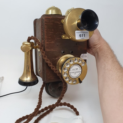 611 - A oak and brass wall mounted phone, GPO 121