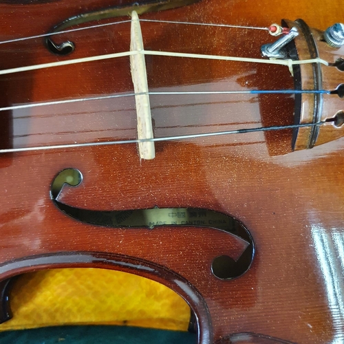 619 - A Chinese violin, with a two piece back, three bows, in case and a miniature violin and bow, in a ca... 