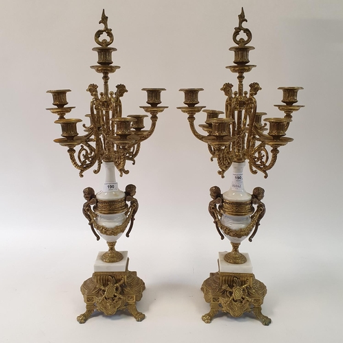 190 - A pair of Victorian style gilt metal seven light candelabra, from a clock garniture, 68 cm high (2)