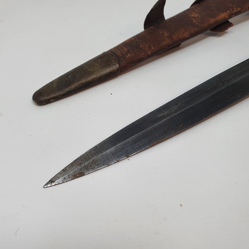 13 - A Fairbairn & Sykes type Commando fighting knife, with a ribbed handle, and a leather scabbard
Prove... 