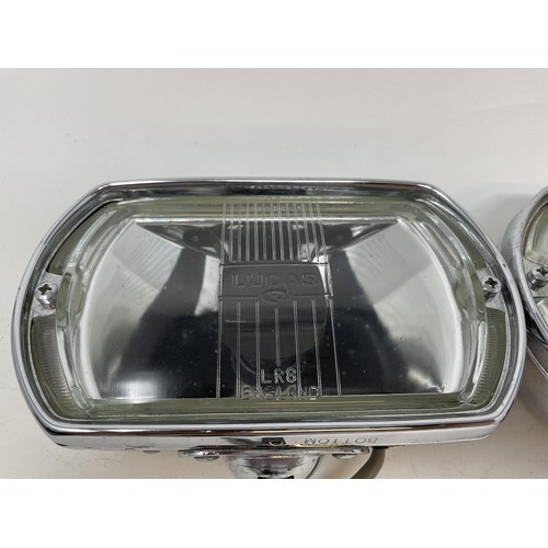 9 - A pair of Lucas Quartz-Halogen driving lamps, with covers, a Cibie driving lamp, with a cover, and a... 