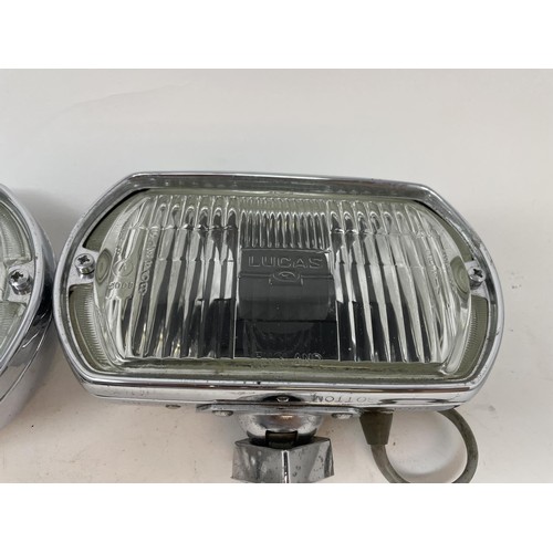9 - A pair of Lucas Quartz-Halogen driving lamps, with covers, a Cibie driving lamp, with a cover, and a... 