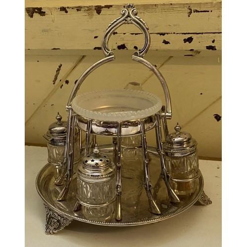 52 - An early 20th century silver plated cruet stand, with central bowl surrounded by mounts in the form ... 