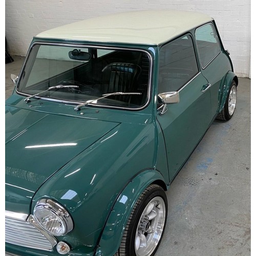 59 - 1971 Mini Cooper S Recreation 
Registration number KFB 656J 
Green with a white roof 
Black interior... 