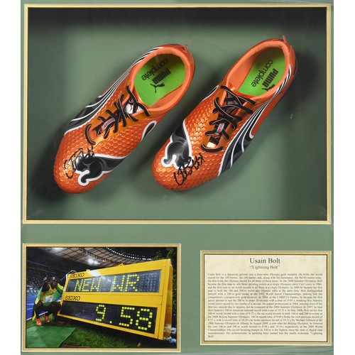 37 - A pair of Puma complete orange shoes, signed by Usain Bolt, the box frame 66 cm high x 62 wide...