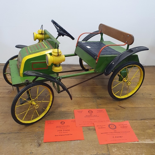 1 - A Tri-ang veteran style child's pedal car, green painted with yellow spoked wheels and dummy plastic...