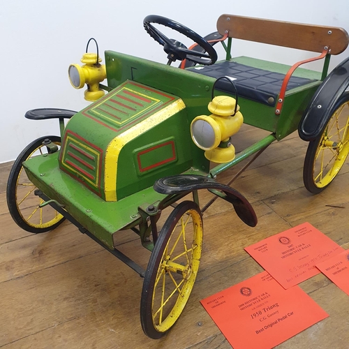 1 - A Tri-ang veteran style child's pedal car, green painted with yellow spoked wheels and dummy plastic...