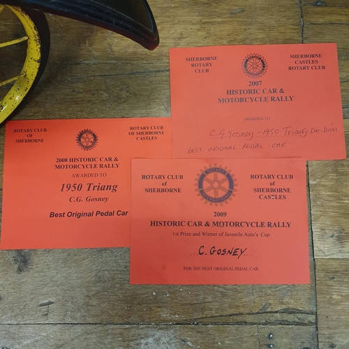 1 - A Tri-ang veteran style child's pedal car, green painted with yellow spoked wheels and dummy plastic...