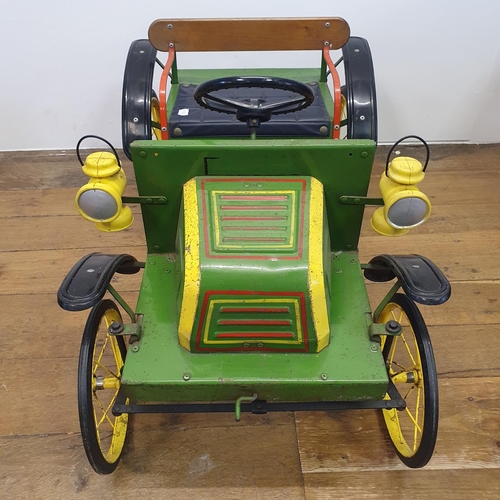 1 - A Tri-ang veteran style child's pedal car, green painted with yellow spoked wheels and dummy plastic...