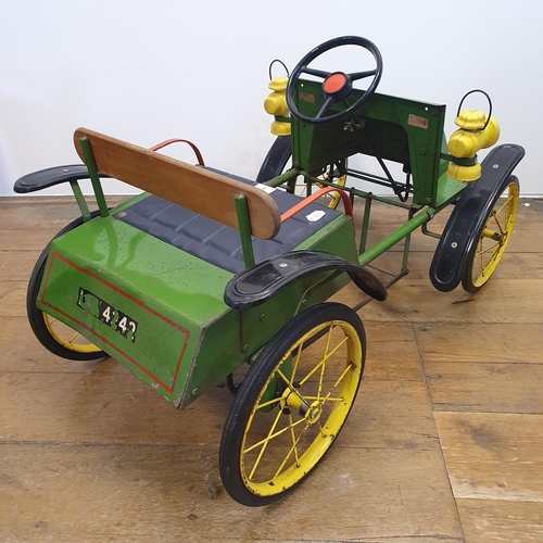 1 - A Tri-ang veteran style child's pedal car, green painted with yellow spoked wheels and dummy plastic...