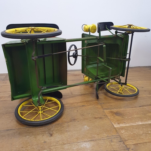 1 - A Tri-ang veteran style child's pedal car, green painted with yellow spoked wheels and dummy plastic...