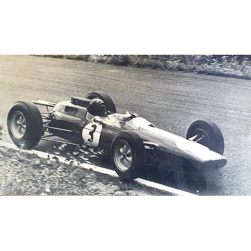 55 - A monochrome picture, Jim Clark driving a Lotus, 39 x 69.5 cm...