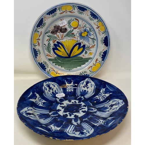 463 - A Delft plate, decorated flowers, 31 cm diameter, three other Delft plates, and a plate (5)