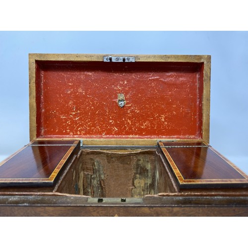 495 - A mahogany tea caddy, 29 cm wide, and a canteen of cutlery (2)