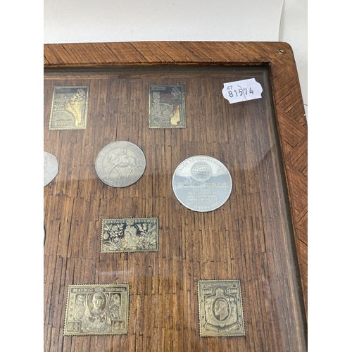 129 - A set of silver postage stamp coin medallions, and other medallions, set in a frame constructed from... 