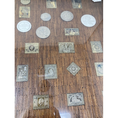 129 - A set of silver postage stamp coin medallions, and other medallions, set in a frame constructed from... 