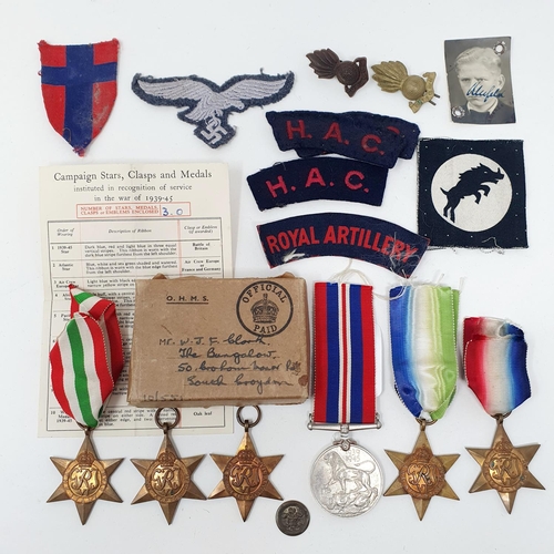 153 - Four WWII Stars, a War Medal, assorted patches and other items